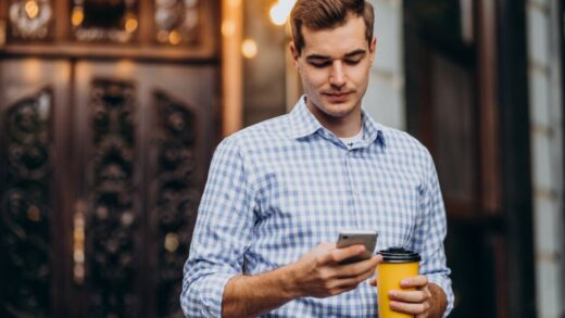 young handsome man drinking coffee outside