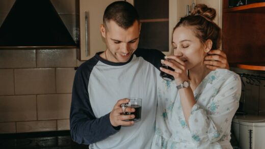 valentines day at home. romantic relationship quality time. couple slow day spent indoors, drinking coffee and hugging in kitchen