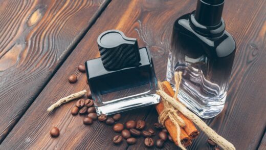black bottle of perfume placed on a wooden table